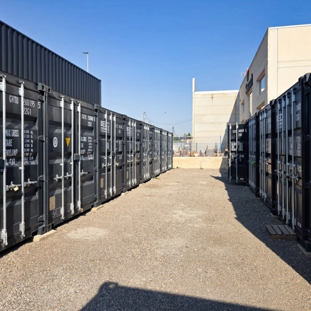 rows of shipping containers in the yard